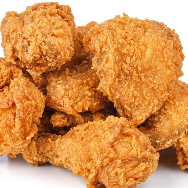 A close-up of several pieces of golden-brown, crispy fried chicken from Harold's 25.