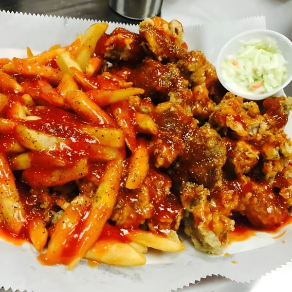 Harold's 25 fried chicken and fries, both smothered in a sweet and spicy sauce, with coleslaw.