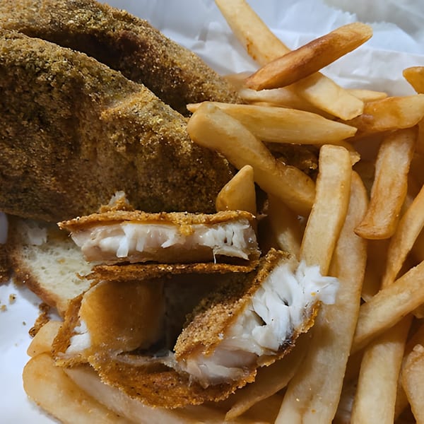 Close-up of crispy fried fish fillets and golden french fries from Harold's 25.