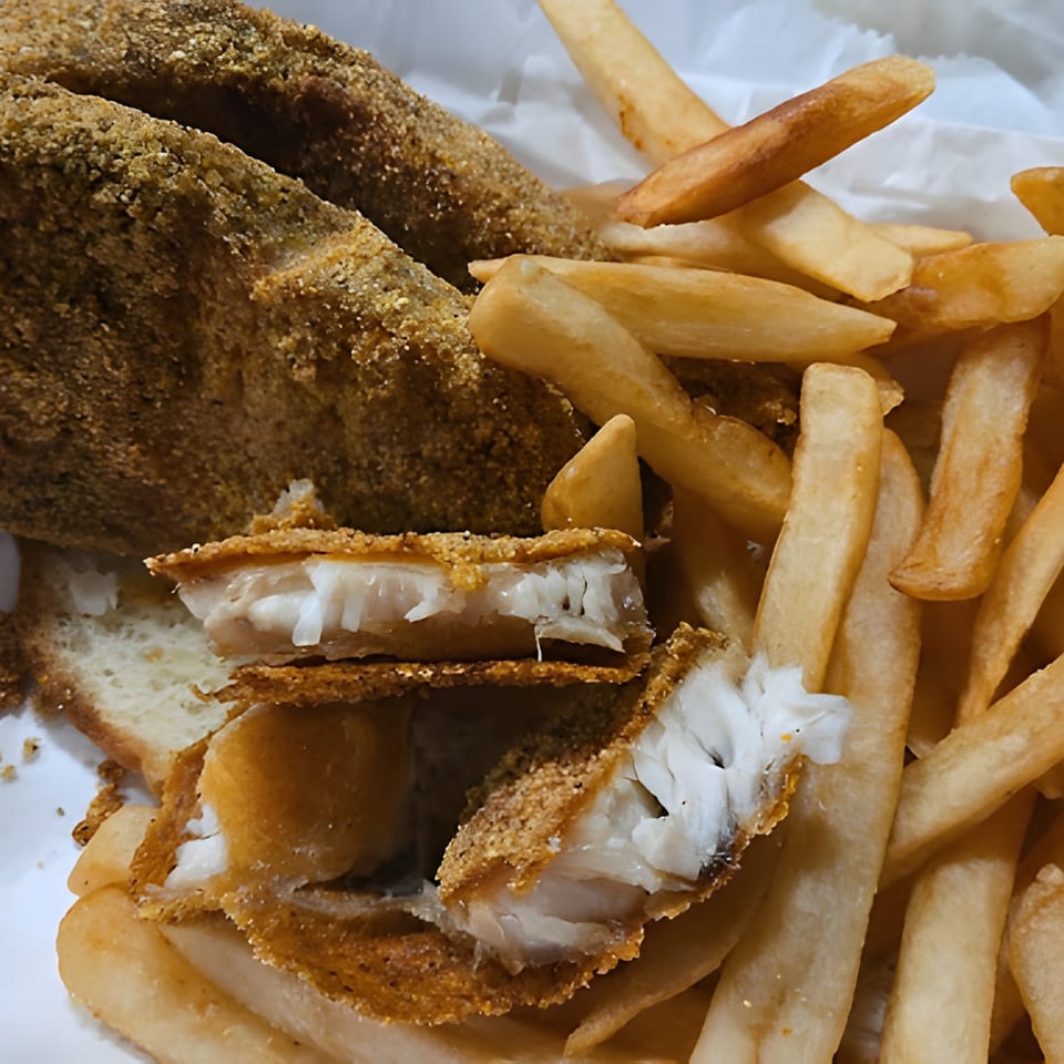 Close-up of crispy fried fish fillets and golden french fries from Harold's 25.